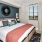 a bedroom with a bed and a fan