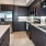 a kitchen with dark cabinets
